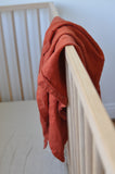 bright terracotta linen swaddle